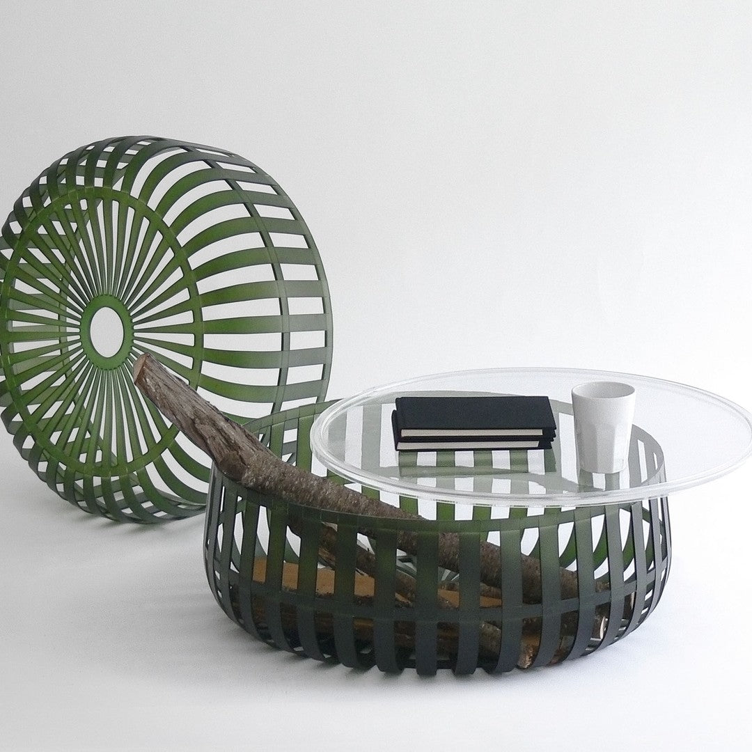 Green striped coffee table and decorative stool with a modern design and natural wooden accents.