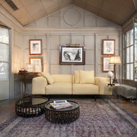 Yellow checkered sofa on a vintage patterned rug, complemented by dark wood and glass coffee tables.