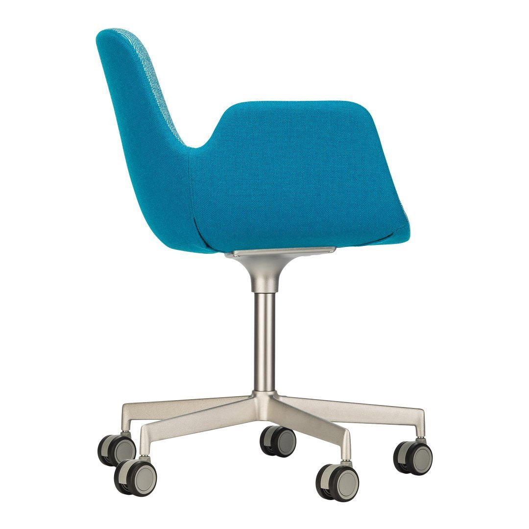 Teal patterned chair with a sleek design and silver rolling base, perfect for modern office spaces.