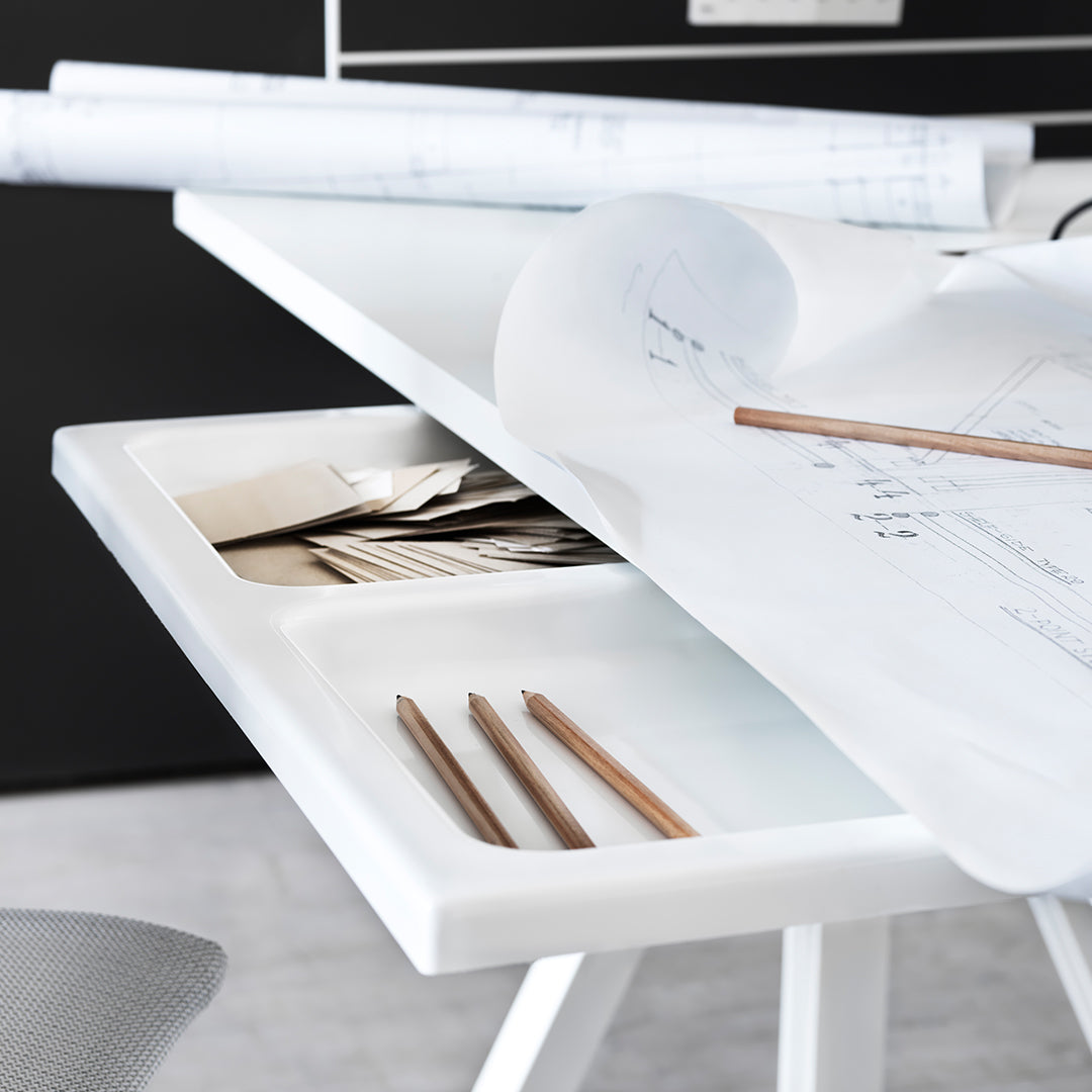 Sleek white desk with smooth surfaces, showcasing neutral patterns and light wood accents.