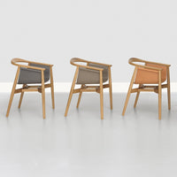 Three chairs with oak frames, featuring gray, beige, and terracotta upholstery in a sleek, modern design.
