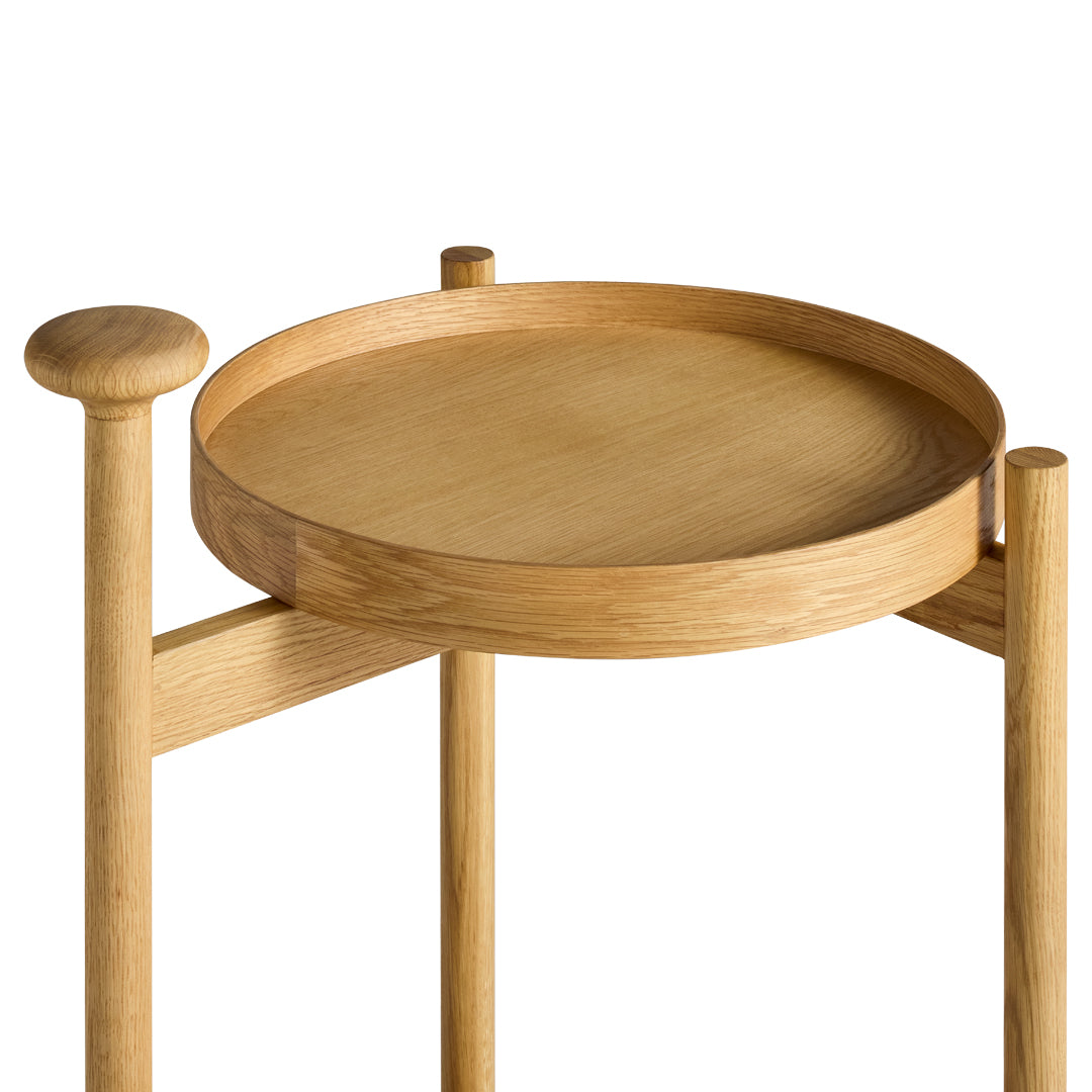 Light oak round tray table with smooth, natural wood finish and minimalist design. Perfect for modern decor.