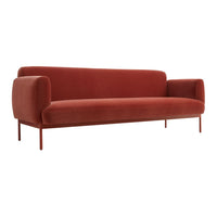 Rust-colored velvet sofa with a smooth texture and minimalist design, featuring rounded armrests and sleek metal legs.