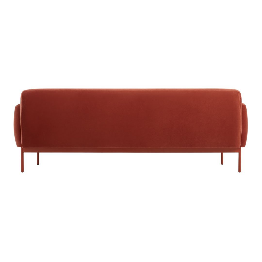 Rust-colored velvet sofa with smooth, minimalist design and rounded armrests, perfect for modern decor.