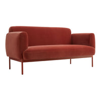 Rust-colored velvet sofa with rounded arms and clean lines, perfect for modern living spaces.