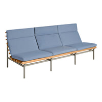 Stylish mid-century modern sofa in light blue fabric with natural wood and metal accents.