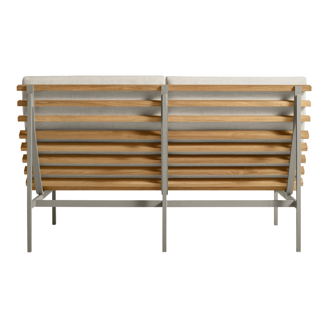 Back view of a modern bench featuring a natural wood slatted design and a sleek metal frame in neutral tones.