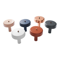 Set of six modern bottle stoppers in hues of terracotta, navy, white, gray, rose, and metallic copper. Stylish design.