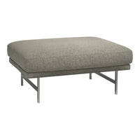 Grey upholstered ottoman with a textured fabric and sleek metal legs, perfect for modern decor.
