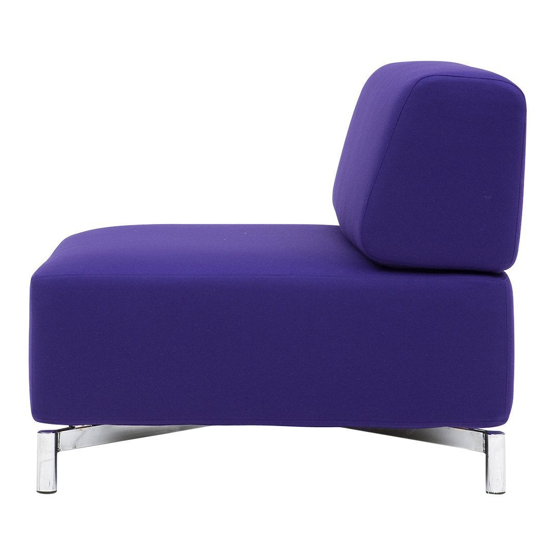 Side view of a modern chair in vibrant purple fabric with sleek chrome legs. Simple and stylish design.