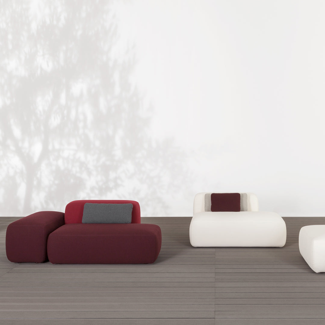 Modern seating with burgundy and cream colors, featuring smooth, rounded shapes and subtle gray accents.
