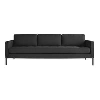 Modern black sofa with sleek design and solid color upholstery, featuring clean lines and minimalistic style.