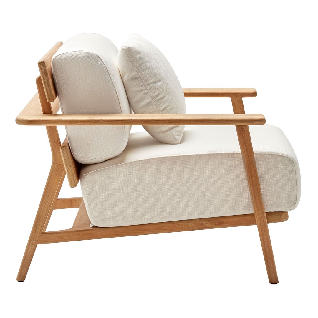 "Minimalist white fabric armchair with natural wood frame and plush cream cushions, perfect for modern decor."