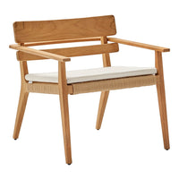 Light wood armchair with a natural wicker seat and a white cushion, featuring minimalist design and soft textures.