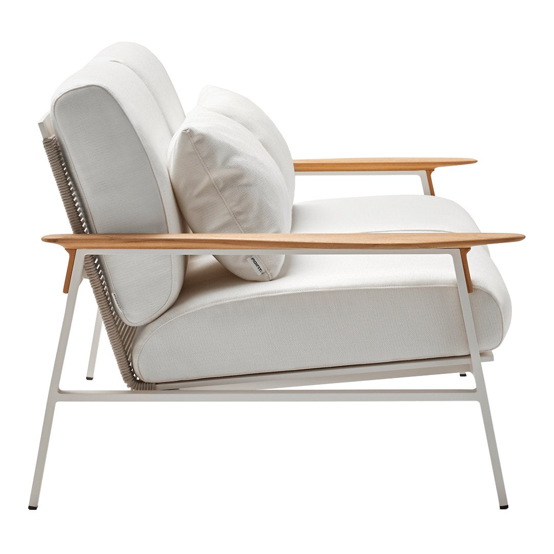 Modern white sofa with wooden accents and plush throw pillows, featuring a sleek, minimalist design.