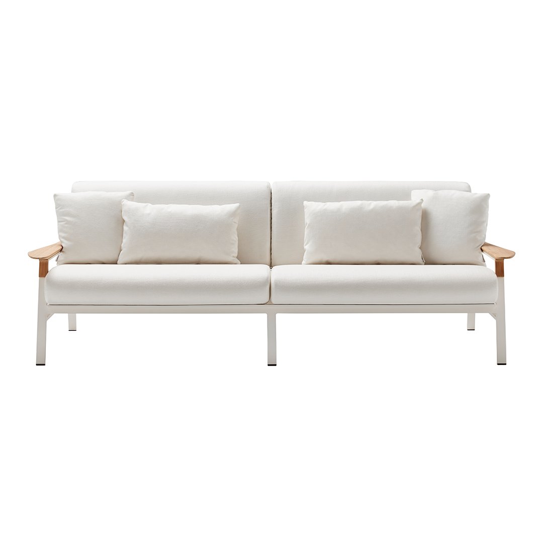 White sofa with cream cushions and light wood accents, featuring a minimalist design and seamless lines.