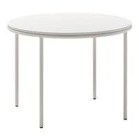 Round white table with a smooth surface and sleek metal legs, perfect for modern dining spaces.