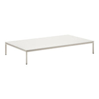 White minimalist coffee table with a smooth surface and sleek metal legs, perfect for modern decor.