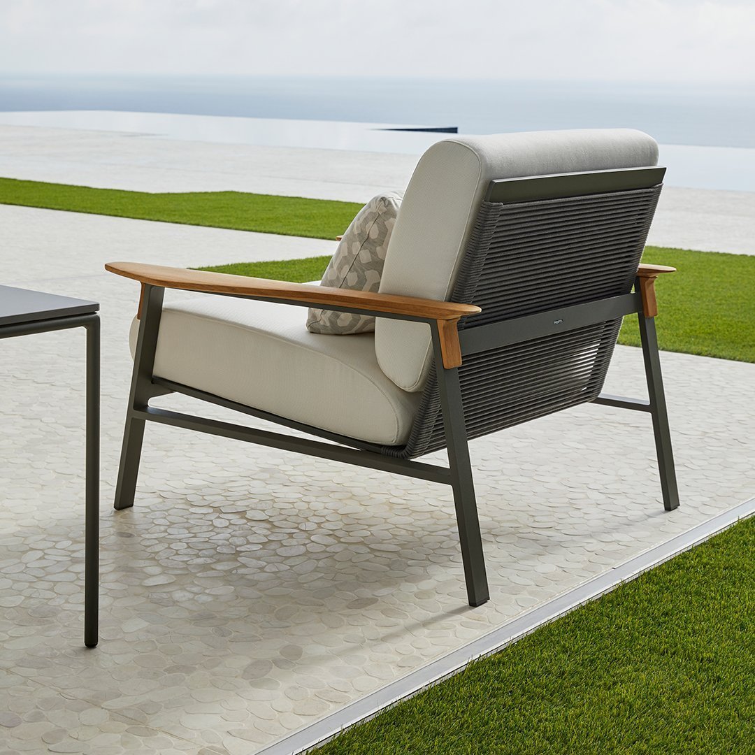 Stylish gray and beige outdoor chair with wooden armrests and subtle textured patterns on cushions and frame.