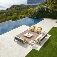"Modern outdoor seating set featuring vibrant yellow cushions, sleek gray frames, and geometric coffee table."
