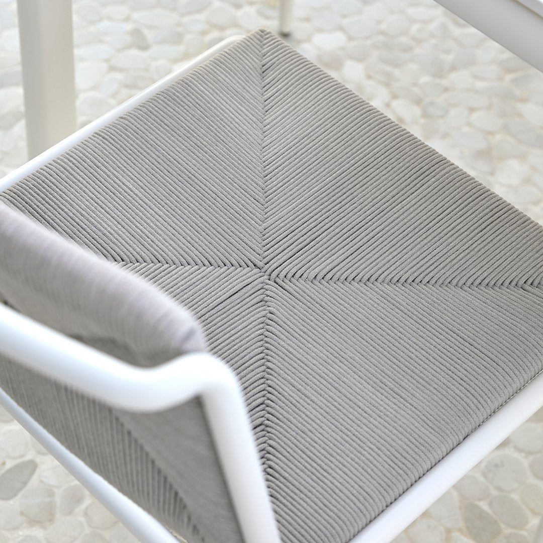 Gray textured chair cushion with a geometric pattern, featuring subtle lines in a diamond design on a light background.