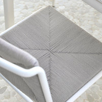 Gray textured chair cushion with a geometric pattern, featuring subtle lines in a diamond design on a light background.