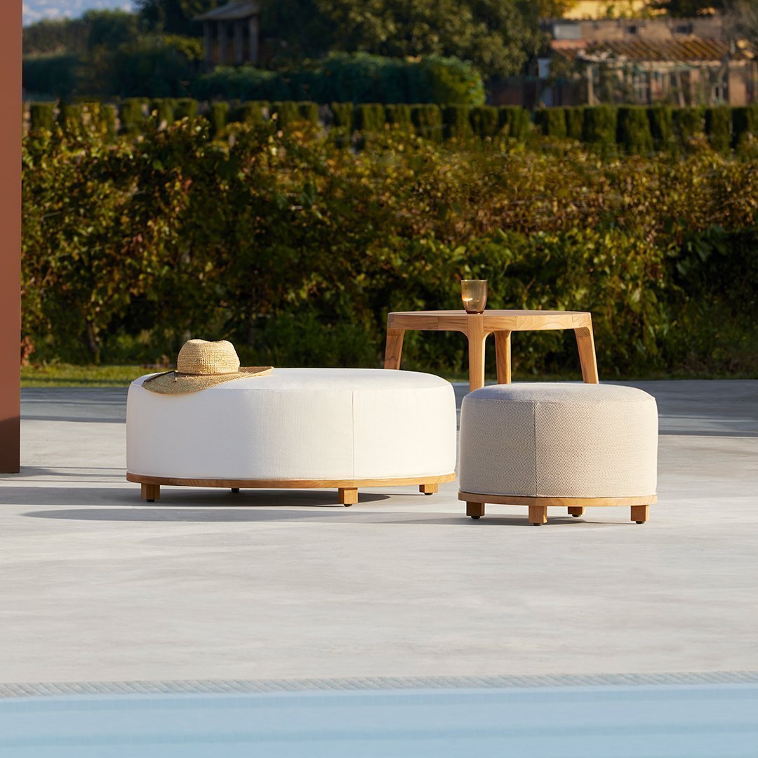 Two modern ottomans in white and beige with natural wood bases, perfect for outdoor or contemporary decor.
