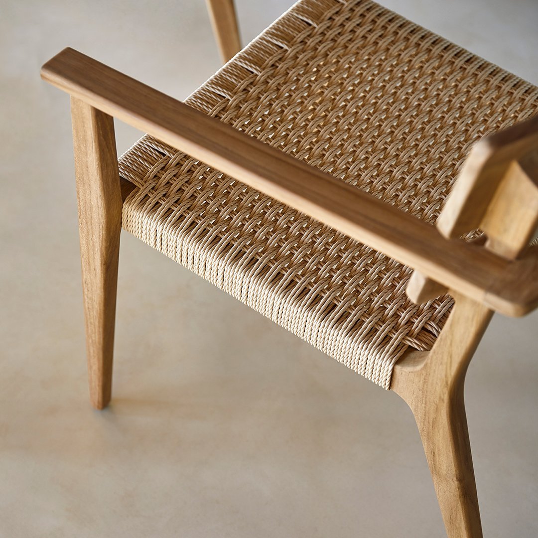 Natural wooden chair with a woven beige seat, featuring a simple, elegant pattern. Ideal for modern decor.