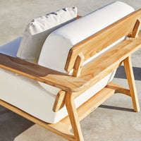 Natural wood finish with light cream upholstery and subtle textured cushion, perfect for modern decor.