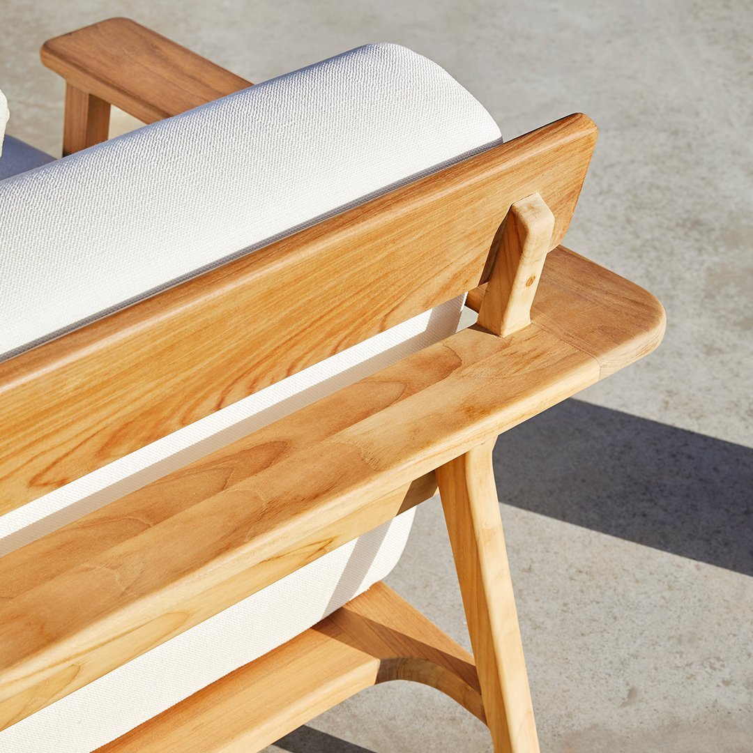 Light wood bench with a white cushion, showcasing a natural finish and minimalist design.
