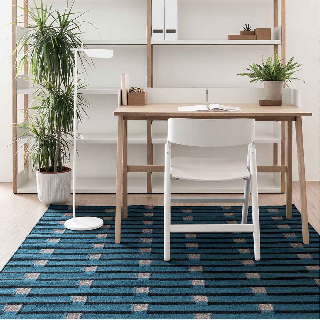 Blue striped area rug with grey and beige accents, perfect for modern home or office decor.