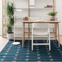 Blue striped area rug with grey and beige accents, perfect for modern home or office decor.