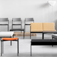 Modern seating in gray, yellow, black, white, and orange; minimalist design with sleek patterns and clean lines.