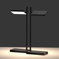 Modern black desk lamp with sleek geometric shapes and a minimalist design. Features a contrasting white light panel.