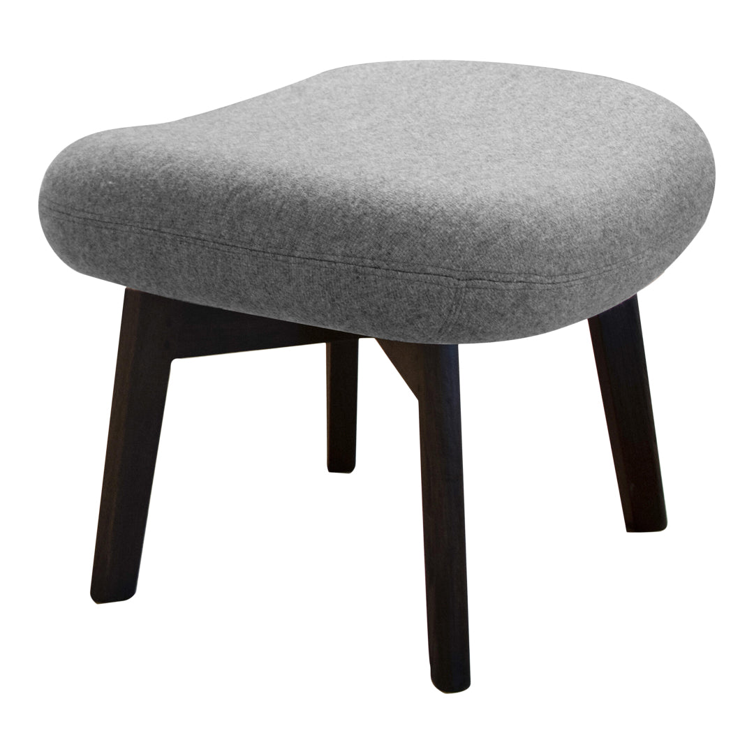 Gray upholstered ottoman with a smooth rounded shape and dark wooden legs, perfect for modern decor.