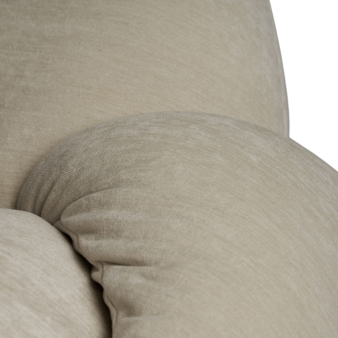 Light beige textured fabric with smooth, rounded contours, perfect for a cozy home decor accent.