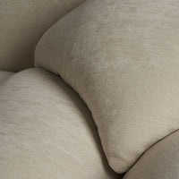 Light beige textured cushions with subtle pattern, adding warmth and softness to any living space.