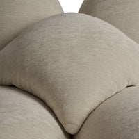 Soft beige cushions with subtle texture, featuring smooth, rounded shapes for a modern aesthetic.