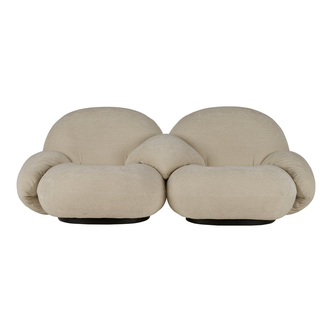 Beige plush loveseat with rounded shapes and soft texture, perfect for modern interior aesthetics.