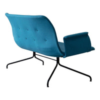 Teal upholstered chair with button tufting and sleek black legs, perfect for modern decor. 