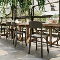 Gray and wooden dining chairs with a sleek design, set against a backdrop of greenery and natural light.