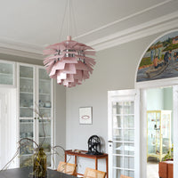 Pink layered pendant light with sleek design, enhancing a modern interior with soft, muted tones.
