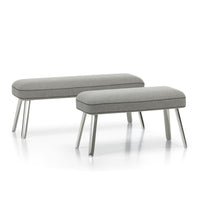 Gray upholstered benches with sleek, light gray legs; minimalist design complements modern decor.