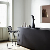Modern black kitchen bar with sleek lines, featuring geometric patterns and minimalistic decor in neutral tones.