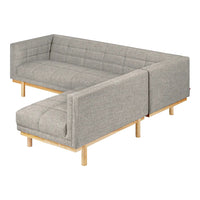 L-shaped sofa in a soft gray fabric with quilted pattern, featuring natural wood legs for a modern touch.