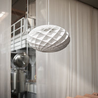 White geometric pendant light with a textured, diamond pattern, creating a modern and elegant look.