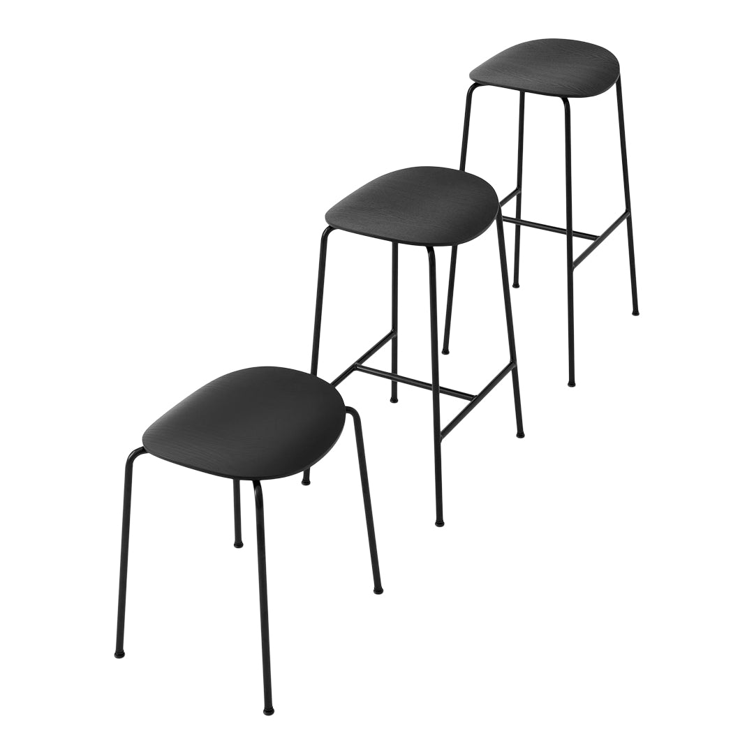Set of three sleek black stools with smooth, minimalist design and slender metal legs, perfect for modern decor.