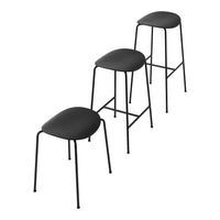 Set of three sleek black stools with smooth, minimalist design and slender metal legs, perfect for modern decor.
