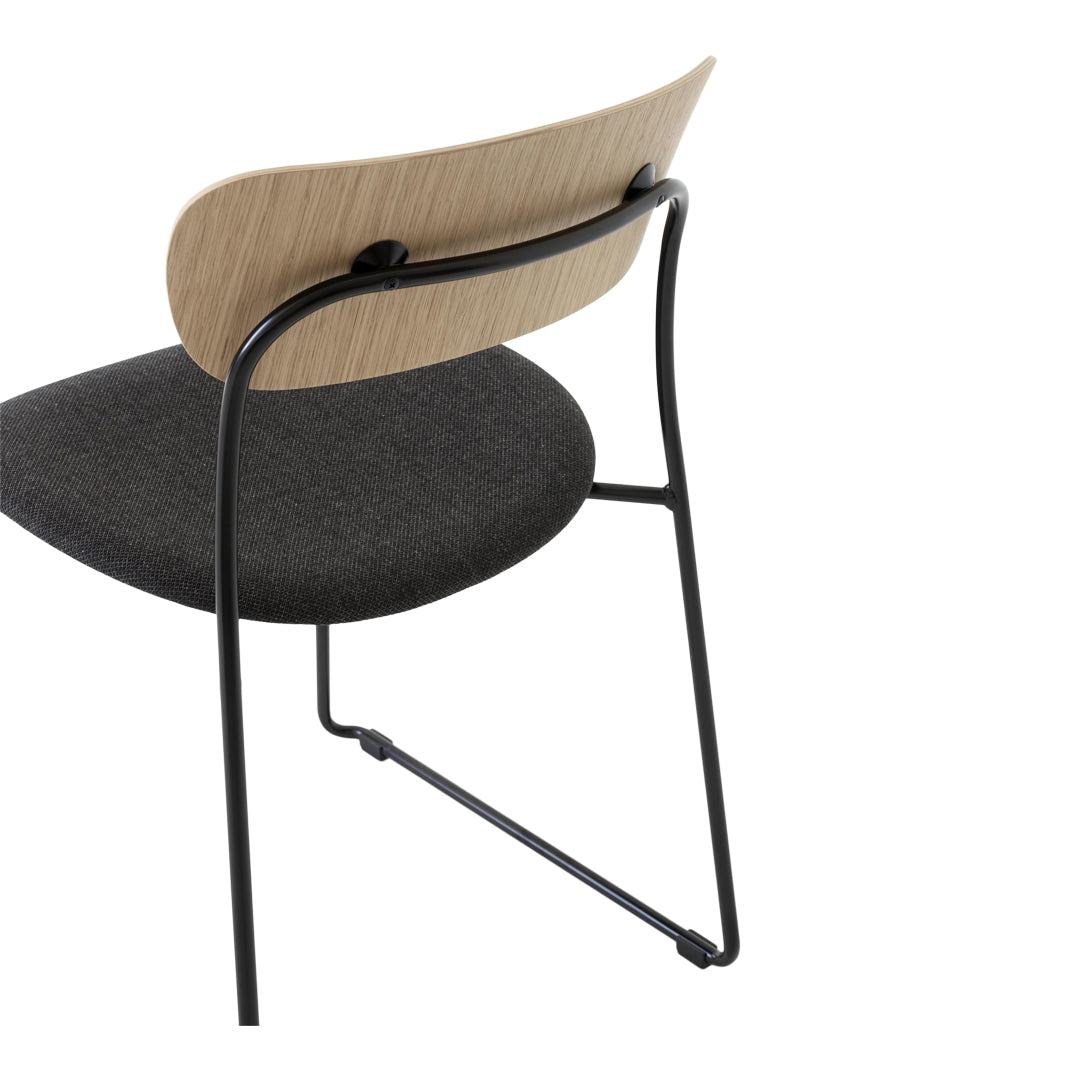 Black metal frame chair with a light wood backrest and dark gray upholstery. Modern design with a minimalist aesthetic.