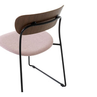 Blush pink cushioned seat with a walnut backrest and black metal legs, offering a modern and stylish look.